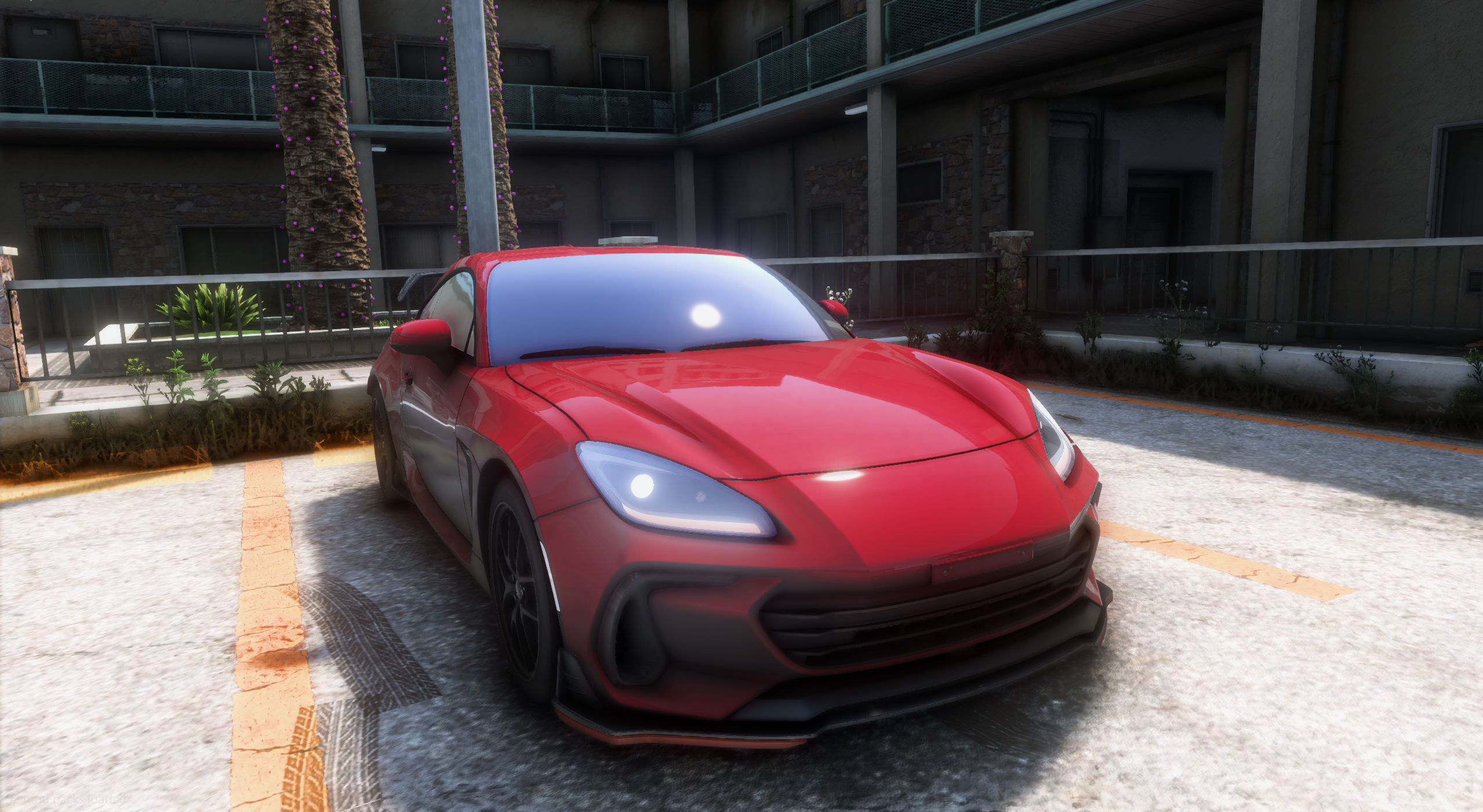 Red sports car parked in bright sunlight