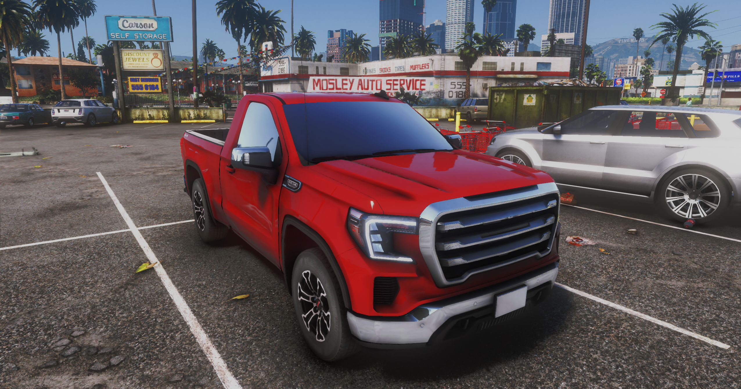 Red pickup truck parked near city shops